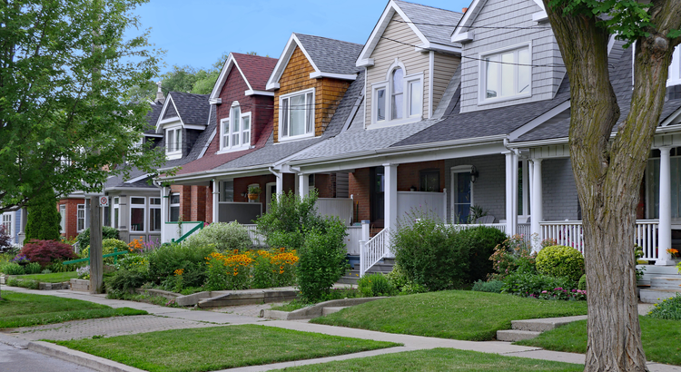 Row of attractive suburban homes with diverse architectural designs and lush landscaping, symbolizing ideal residential properties for prospective homeowners.