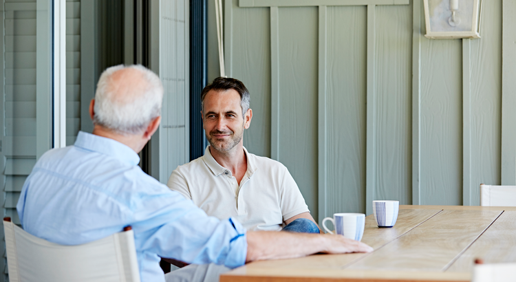 Two men having a relaxed conversation over coffee, symbolizing personalized and friendly mortgage consultations.