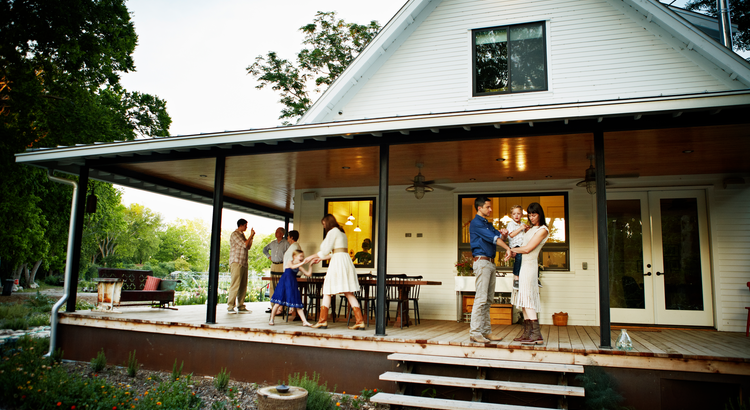 Family gathering on the porch of a multi-generational home, symbolizing the benefits and affordability of multi-generational living.