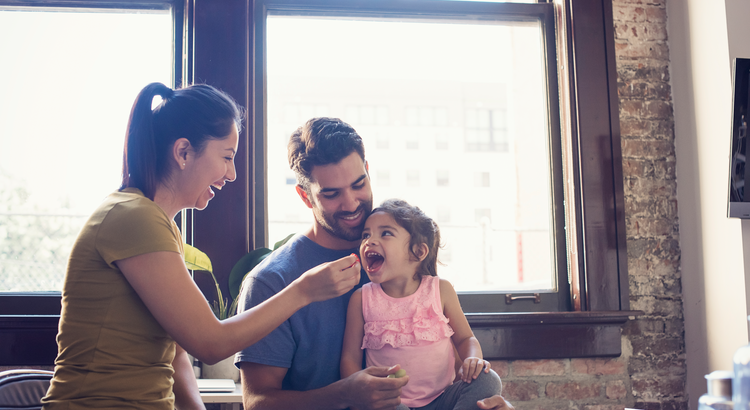 Happy family spending time together at home, symbolizing the life-changing events that impact the housing market.