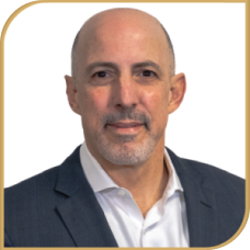 Jim Abreu smiling in a suit, looking confident and professional.