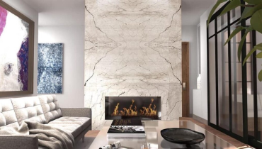 Interior view of a modern living room featuring a large fireplace and stylish decor.