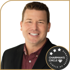 Nick Carter in a blazer, smiling confidently with a Chairman’s Circle badge.